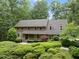 Well-maintained brick home surrounded by lush greenery, creating a private setting at 2300 Valley Forge Dr, Raleigh, NC 27615