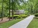 Traditional brick home featuring a lush, landscaped front yard and a long driveway at 2300 Valley Forge Dr, Raleigh, NC 27615