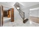 Bright foyer with marble floors, staircase, and traditional trim at 2300 Valley Forge Dr, Raleigh, NC 27615