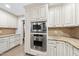 Bright kitchen with stainless steel microwave and oven encased in white custom cabinetry at 2300 Valley Forge Dr, Raleigh, NC 27615