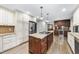 Spacious kitchen with center island, stainless steel appliances, and custom cabinetry at 2300 Valley Forge Dr, Raleigh, NC 27615