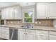 Updated kitchen with a stainless steel sink, dishwasher, and neutral countertops at 2300 Valley Forge Dr, Raleigh, NC 27615