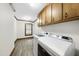 Laundry room features modern washer and dryer units and wood trim at 2300 Valley Forge Dr, Raleigh, NC 27615