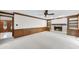 Living room with a fireplace, built-in shelves, and classic wood paneling at 2300 Valley Forge Dr, Raleigh, NC 27615