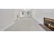 Spacious living room featuring a fireplace, carpet flooring, and plenty of natural light at 2300 Valley Forge Dr, Raleigh, NC 27615