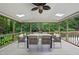 Screened-in porch featuring skylights, fan, and outdoor dining area at 2300 Valley Forge Dr, Raleigh, NC 27615