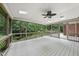 Screened-in porch has ceiling fan, skylights, and views of greenery at 2300 Valley Forge Dr, Raleigh, NC 27615