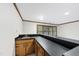 Basement wet bar with wood cabinets, contrasting countertop and built-in sink at 2300 Valley Forge Dr, Raleigh, NC 27615