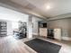 Spacious basement area with laminate flooring, workout area, wet bar, and small entertainment center at 2303 Byrd St, Raleigh, NC 27608
