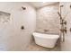 Luxurious bathroom showcasing a freestanding tub and a stylish shower with tiled walls at 2303 Byrd St, Raleigh, NC 27608