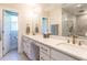 Bright bathroom featuring double sink vanity, modern fixtures, and a glass-enclosed shower at 2303 Byrd St, Raleigh, NC 27608