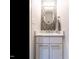 Powder room features a marble vanity, mosaic backsplash, modern faucet and elegant mirror at 2303 Byrd St, Raleigh, NC 27608