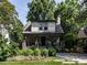 Charming two-story home with landscaped front yard and inviting covered porch with stone accents at 2303 Byrd St, Raleigh, NC 27608