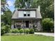 Charming two-story home featuring stone accents, a cozy front porch, and professionally landscaped front yard at 2303 Byrd St, Raleigh, NC 27608