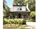 Charming home featuring a beautiful front yard with a stone porch, lush landscaping, and a cozy seating area at 2303 Byrd St, Raleigh, NC 27608