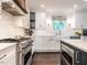 Bright kitchen featuring white cabinets, stainless steel appliances, and a center island at 2303 Byrd St, Raleigh, NC 27608