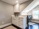 Modern laundry area with white cabinets, sink, and front-load washer and dryer at 2303 Byrd St, Raleigh, NC 27608