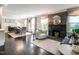 Open-concept living space with fireplace, dining area, and dark wood floors at 2303 Byrd St, Raleigh, NC 27608