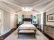 Main bedroom features a tray ceiling, area rug, natural lighting, and modern decor at 2303 Byrd St, Raleigh, NC 27608