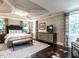 Main bedroom features a tray ceiling, area rug, natural lighting, and modern decor at 2303 Byrd St, Raleigh, NC 27608