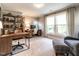Bright office with built-in shelving, two desks, and comfortable seating area near windows at 2303 Byrd St, Raleigh, NC 27608