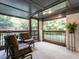 Cozy screened-in patio with plenty of seating overlooking the yard and mature trees at 2303 Byrd St, Raleigh, NC 27608