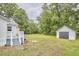 Spacious backyard with detached garage and mature trees provides shade at 2418 Highland Ave, Durham, NC 27704