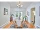 Bright dining room with hardwood floors, a window view, and a stylish chandelier at 2418 Highland Ave, Durham, NC 27704