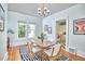 Charming dining room featuring a modern light fixture and an interior window view at 2418 Highland Ave, Durham, NC 27704