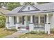 Attractive home featuring a charming front porch with stylish accents and a well-maintained lawn at 2418 Highland Ave, Durham, NC 27704