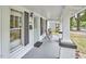 Welcoming front porch with dark shutters, neutral colors, and a cozy seating area at 2418 Highland Ave, Durham, NC 27704