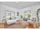 Sunlit living room featuring hardwood floors, neutral decor, and stylish furnishings at 2418 Highland Ave, Durham, NC 27704