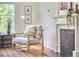 Cozy living room featuring a fireplace and chair, filled with natural light at 2418 Highland Ave, Durham, NC 27704