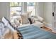 Bedroom window nook with natural light, hardwood floors and comfortable seating at 2418 Highland Ave, Durham, NC 27704
