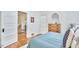 Bedroom with hardwood floors, dresser, and doorway leading to the living room at 2418 Highland Ave, Durham, NC 27704