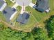 An aerial view of a house with solar panels on the roof in a cul-de-sac with a well-maintained lawn at 2636 Nordmann Fir Rd, Raleigh, NC 27616