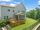 Spacious backyard features a well-maintained lawn, wooden deck, screened porch, and black metal fence at 2636 Nordmann Fir Rd, Raleigh, NC 27616