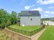Fenced-in backyard with a lush lawn, complemented by solar panels on the roof at 2636 Nordmann Fir Rd, Raleigh, NC 27616