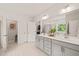 Bright bathroom features double sinks, light gray cabinetry, white countertops, and neutral tile flooring at 2636 Nordmann Fir Rd, Raleigh, NC 27616