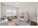 Bright bedroom featuring a tented bed, hardwood floors, and lots of natural light from the large window at 2636 Nordmann Fir Rd, Raleigh, NC 27616