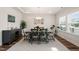 Elegant dining room featuring hardwood floors, modern lighting, and ample seating space at 2636 Nordmann Fir Rd, Raleigh, NC 27616