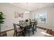 Bright dining room with dark wood table, light gray chairs and recessed lighting at 2636 Nordmann Fir Rd, Raleigh, NC 27616