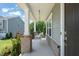 Welcoming front porch featuring a cozy porch swing, brick accents, and manicured greenery at 2636 Nordmann Fir Rd, Raleigh, NC 27616