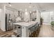 Open concept kitchen with a large island with counter seating and stainless steel appliances at 2636 Nordmann Fir Rd, Raleigh, NC 27616