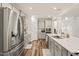 Spacious kitchen featuring stainless steel appliances, gray cabinets, and a large island at 2636 Nordmann Fir Rd, Raleigh, NC 27616