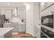 Modern kitchen featuring gray cabinetry, stainless steel appliances, and a subway tile backsplash at 2636 Nordmann Fir Rd, Raleigh, NC 27616