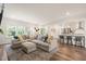 Open concept living area with comfortable seating, natural light, and kitchen access at 2636 Nordmann Fir Rd, Raleigh, NC 27616