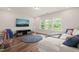 Spacious living room with hardwood floors, large windows offering great views, and comfortable seating at 2636 Nordmann Fir Rd, Raleigh, NC 27616