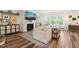 Bright living room with a fireplace, large TV, and hardwood floors at 2636 Nordmann Fir Rd, Raleigh, NC 27616