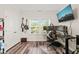 Well-lit office with two guitars on the wall, desk with dual monitors, and a large screen TV at 2636 Nordmann Fir Rd, Raleigh, NC 27616